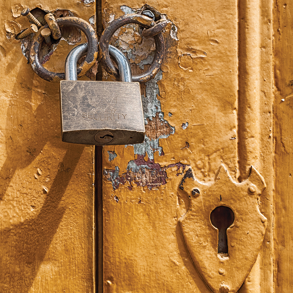 Padlock on a rusted door