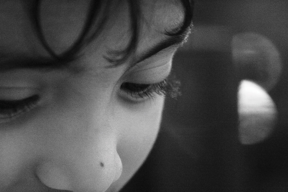 A black and white photograph close-up of a child's face