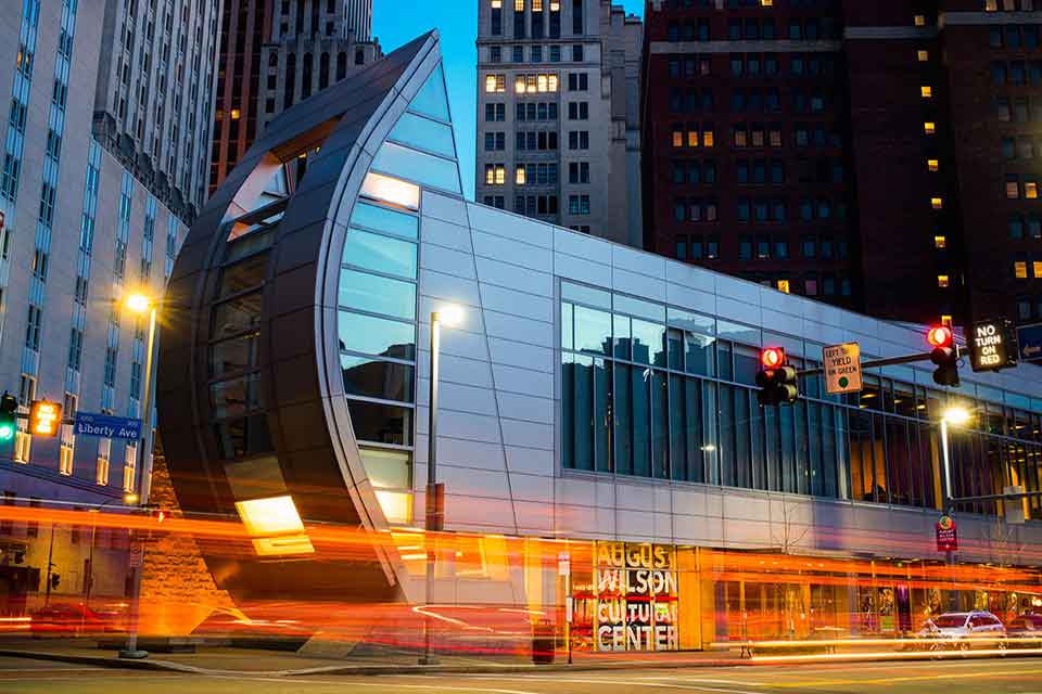 An exterior shot of the August Wilson African American Cultural Center at dusk