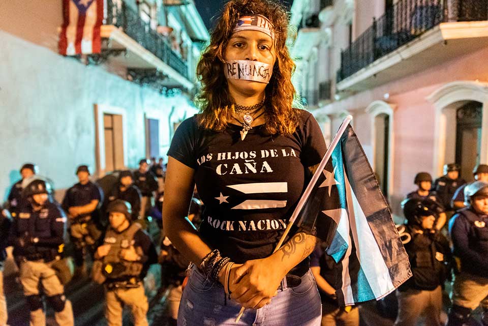 A photograph of a group of protestors staring at the camera