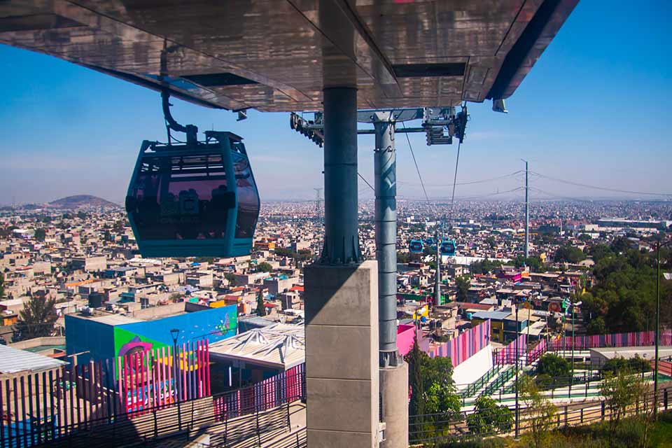 A cable car hovering above the skyline of Mexico City