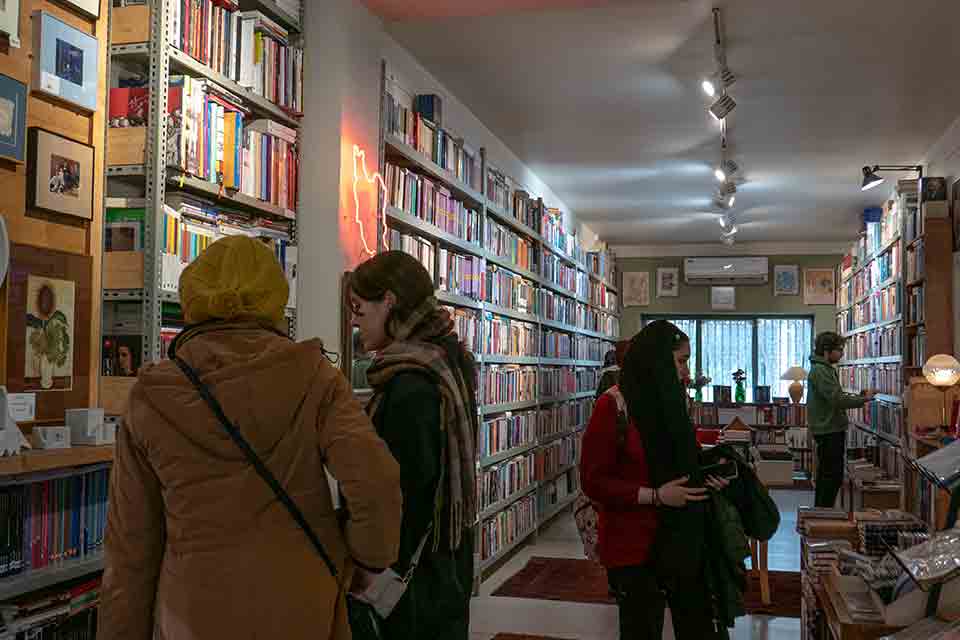 Women shopping in a bookstore. Their hair is veiled.