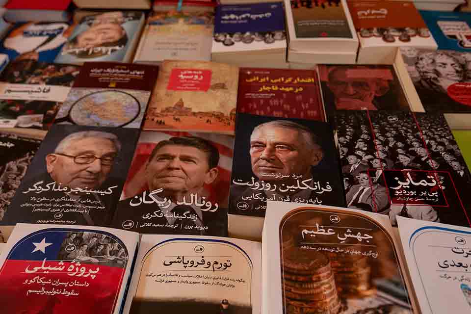A table full of books with Persian text on the covers