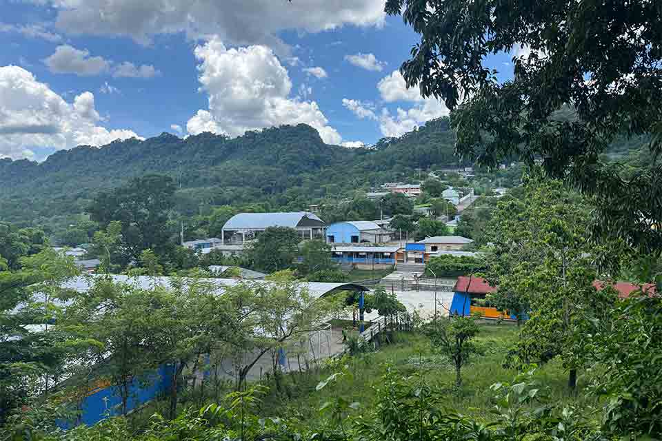 Building hug the face of a forested mountain