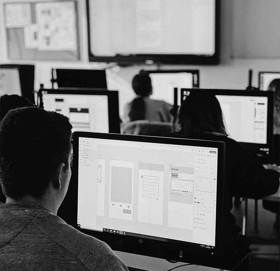 Students sitting in front of their computers in class
