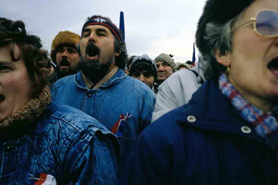 People standing in a crowd protesting