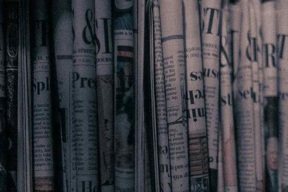 A grainy photograph of many newspaper folded up side by side