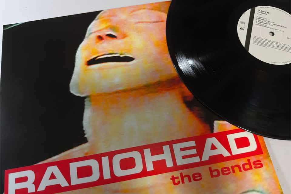 The cover to The Bends by Radiohead. A vinyl album lays on the cover.