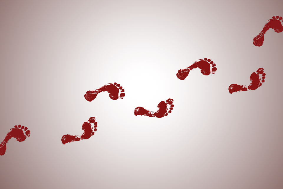 Footprints made in red across a white surface
