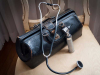 A medical bag with a stethoscope and an otolaryngioscope visible