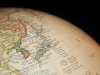 A detail of a globe that is rotated to display Japan and Korea