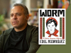 A photograph of Edel Rodriquez with the cover to his book Worm