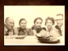 An aged picture of a family gathered around a table