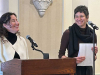 Guadalupe Nettel stands at the lectern laughing while Rosalind Harvey watches her, smiling