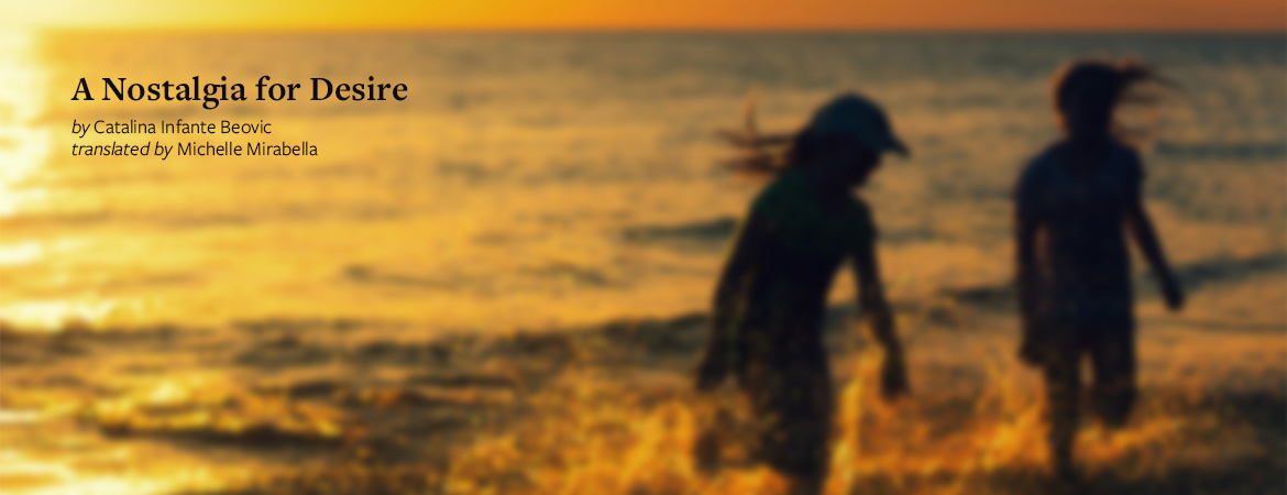 A gauzy photograph of two children playing in the surf. The sun is setting and they are mostly swallowed in shadow