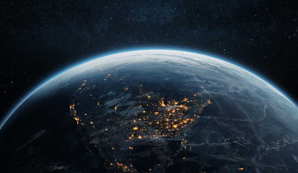 The Earth from space with United States facing the viewer, lit up by city lights below