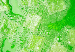 Ice-cubes floating in a fizzy green liquid