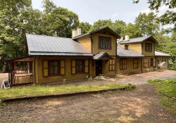 The Markučiai Manor Museum: A rough hewn wooden home surrounded by trees