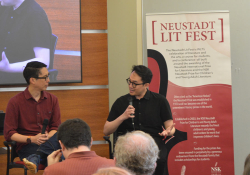 A photograph of Trung Lê Nguyễn and Gene Luen Yang talking at the 2023 Neustadt Lit Fest
