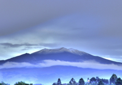 A photograph of a distant snow covered mountain top