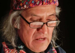 Humberto Ak’abal looks down at his text as he reads aloud