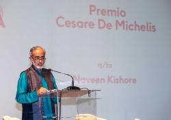 A photograph with a man standing at a lectern