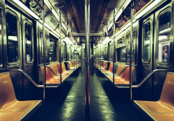 A photograph of the long interior of a subway car