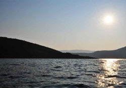 A photograph of a sunrise over the waters off of Ithaca in Greece