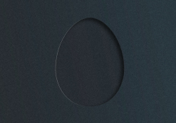 A hole cut out of a piece of black matte card stock, revealing black matte card stock beneath