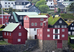 Colorful, geometrically tangent houses cascade up a hill