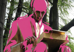 A statue of Indro Montanelli, sitting and reading, with pink digitally added to cover him